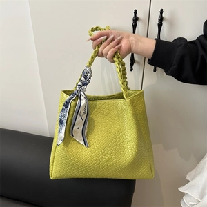 Chic lime green woven tote bag with silk scarf accessory for casual summer styling