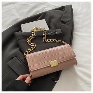 Détail du sac rose motif crocodile avec bandoulière à grosse chaîne dorée brillante