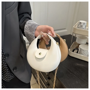 Detail of crescent shoulder bags in beige and brown with gold chain and magnetic buckle
