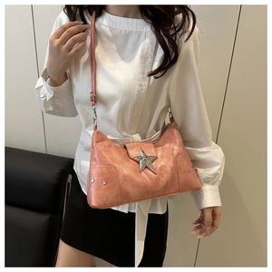 Detail of pink faux leather shoulder bag with silver star studs and vintage texture