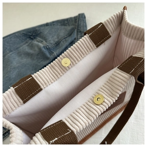 Top view of corduroy tote bag showing interior lining and dual golden magnetic closures