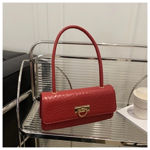 Detail of red faux leather woven texture and golden buckle on this vintage shoulder bag