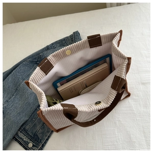 Top view of corduroy tote bag showing internal storage with iPad and magnetic snap closure
