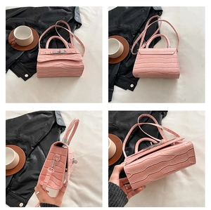 Detailed views of pink crocodile embossed handbag showing metal twist lock and stitching