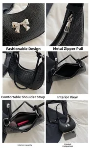 Detail view of woven black crescent bag showing silver bow hardware and internal capacity