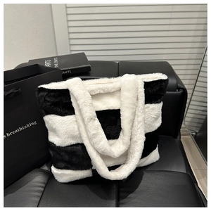Detailed view of striped faux fur tote bag showing soft texture and large capacity