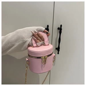 Detail der rosa Mini-Beuteltasche mit goldenen Beschlägen und Doppelreißverschluss