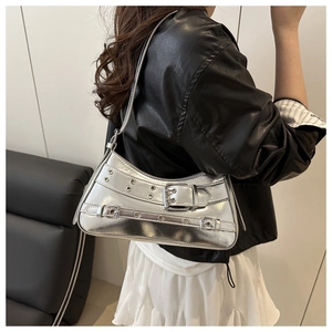 Detailed view of silver metallic Y2K shoulder bag with decorative straps and eyelets