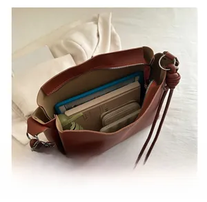 Brown leather tote bag interior showing large capacity for tablet, umbrella and wallet
