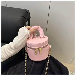 Nahaufnahme der rosa Leder-Beuteltasche mit goldenen Reißverschlüssen und Handgriff