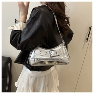 Silver mirror PU underarm bag with metal buckles and eyelets shown on a shoulder