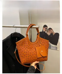 Brown tote bag with clover pattern and detachable mini coin purse accessory