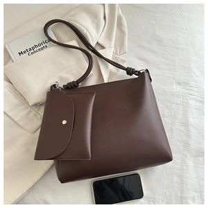 Detailed view of dark brown minimalist tote bag with detachable small pouch and long straps