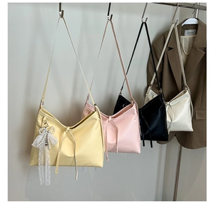 Detail showing colorful hobo bags with lace pearl bow charm and long tassel accents