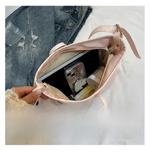Top view of large pink tote bag interior showing ample capacity for gadgets and cosmetics
