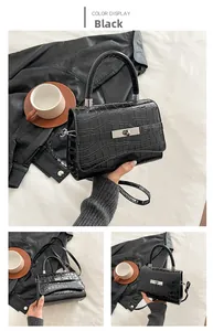 Detailed macro view of black crocodile pattern leather handbag with silver metal clasp
