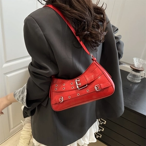 Fashionable red leather underarm bag with silver buckles and retro biker style details