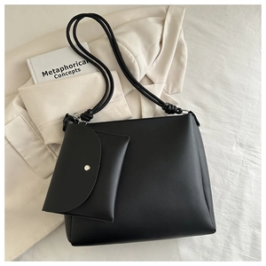 Minimalist black matte tote bag set with knotted shoulder strap and matching small pouch
