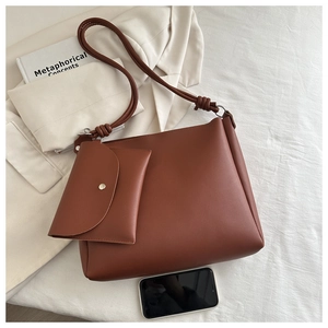Top view of brown PU leather tote set with knot detail and matching flap pouch