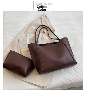 Detail view of coffee brown tote bag set with matching zipper pouch on minimalist background