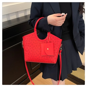 Red tote bag with clover pattern and mini pouch accessory on a blue blazer model outfit