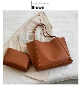 Brown leather tote bag set including large shoulder bag and matching small pouch