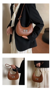 Detail of brown croc-embossed crescent bag with silver bow buckle and knotted shoulder strap