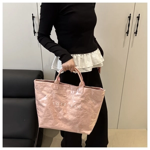 Detailed view of pink crinkled paper texture tote bag with white TOTE BAG text print