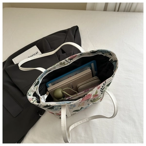 Top view of large floral tote bag showing spacious interior with laptop and umbrella