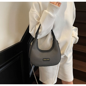 Detail of dark grey woven hobo bag with gold Miss mini logo and chain strap