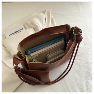 Inside view of brown minimalist tote bag showing spacious capacity for tablet and umbrella