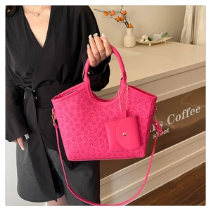 Detailed fuchsia tote bag with embossed clover patterns and matching hanging coin purse