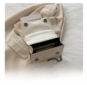 Detailed internal view of off-white crocodile pattern square bag showing daily capacity