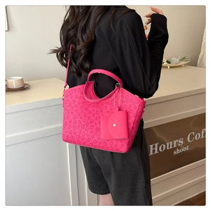 Close-up of hot pink tote bag with clover texture and small coin purse attachment