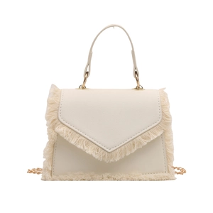 Creamy white crossbody bag with fringe details and a stylish gold chain strap