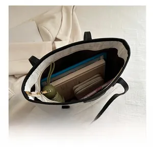 Interior view of off-white tote bag showing organized storage for tablets and umbrellas