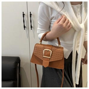 Brown crossbody bag with woven texture flap and large gold square buckle detail