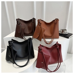 Detail of four colorful bucket bags with knotted handles and matching mini pouches