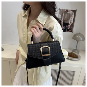 Close-up of a black woven leather crossbody bag featuring a classic gold square buckle