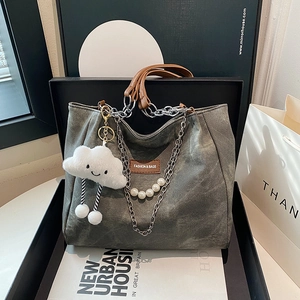 Minimalist grey canvas tote bag with metal chains and pearl cloud pendant accessories