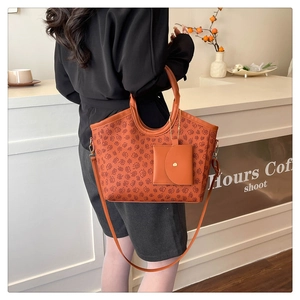 Detail of floral tote bag with shoulder strap and mini coin purse in a cozy cafe setting