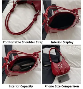 Detail view of red underarm bag with knotted strap, silver eyelets and internal capacity