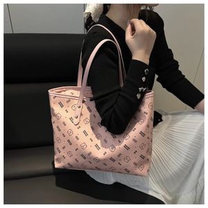 Close-up of pink tote bag with bear pattern and textured leather material details