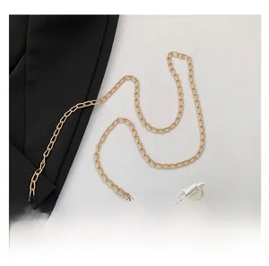 Detail of elegant gold metal chain strap with secure lobster clasps for shoulder bags
