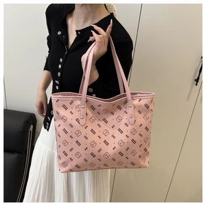 Close-up of pink tote bag with bear pattern, textured faux leather and gold hardware