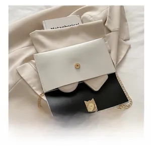 Detail view of the two-tone envelope chain bag interior showing daily storage capacity