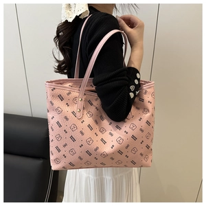 Detail of pink tote bag with bear pattern showing texture and slim shoulder strap