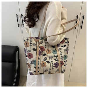 Detail of vintage floral print fabric tote with durable light brown faux leather strap