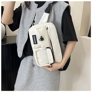 White nylon shoulder bag detail featuring adjustable strap and multi-pocket functional design
