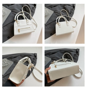 Detail view of white lychee pattern tote bag with metal zipper and adjustable strap